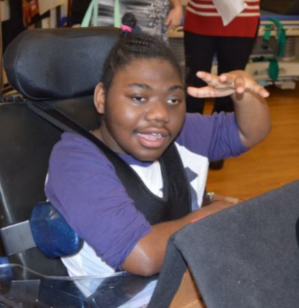 A student sitting in a wheel chair facing the camera.